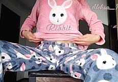 Young girl in pajamas plays with black vibrator, reaching orgasm on webcam