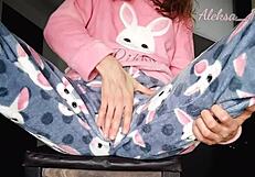 Young girl in pajamas plays with black vibrator, reaching orgasm on webcam