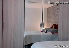 Busty amateur masturbates in pink lingerie on webcam.