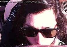 Latina brunette blows on tall bridge.