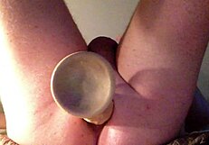 she stretches her ass with a huge dildo, fucking it deep