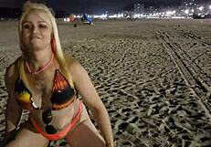 Look at this blonde showing her tits and pussy on the beach!