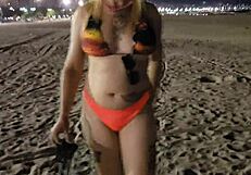 Look at this blonde showing her tits and pussy on the beach!