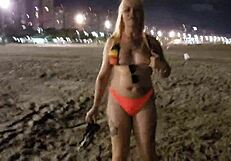 Look at this blonde showing her tits and pussy on the beach!