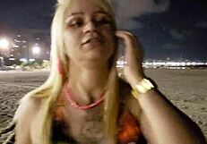 Look at this blonde showing her tits and pussy on the beach!