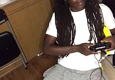 Ebony babe gives head while gaming