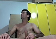 He performs a striptease, revealing his big erect dick