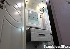 Naked blonde girlfriend applies makeup in bathroom pov