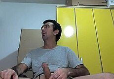 He performs a striptease, revealing his big erect dick