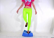 Beautiful legged woman steps on cushion with high heels, showcasing her shoe fetish.