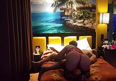 Peruvian girl in red corset poses with her amateur couple at home