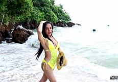 Hey, check out this Asian trans girl in yellow bikini giving a handjob outdoors
