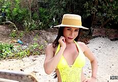 Hey, check out this Asian trans girl in yellow bikini giving a handjob outdoors