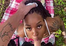 Ebony Teen Slut Enjoys Sucking Hard Dick Outside in Public Interracial Oral Scene. Her Skills Shine Under the Open Sky.