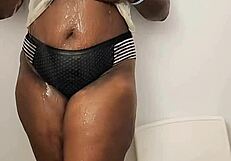 ebony babe masturbates in shower while clothed