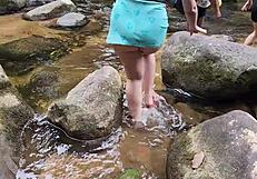 Strolling casually by the waterfall with a stunning big ass