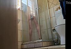 Oh wow, I caught my stepmom fucking her pussy with a glass dildo in the shower!