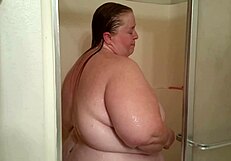 Kitania K Wildfire Showers, Revealing Her Big Tits and Ass Under the Water.