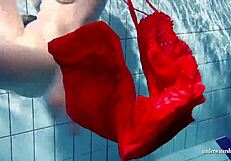 Russian teen Lucie enjoys underwater swimming in the pool.