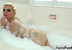 Sexy blonde Nadia White enjoys a relaxing bath time session