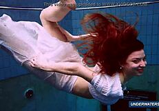 Amazing brunette shows off hairy body in underwater bikini.