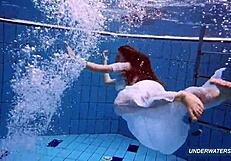 Amazing brunette shows off hairy body in underwater bikini.