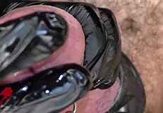 Extreme close-up of latex gloves on peehole with intense cumshot
