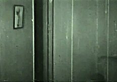 in this retro scene, a woman undresses and gives a blowjob