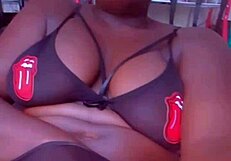 Mature ebony woman in lingerie pleasures her big tits endlessly