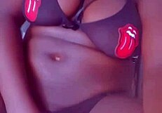 Mature ebony woman in lingerie pleasures her big tits endlessly