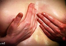 The MILF with natural tits pleasures her husband's big oiled cock with a perfect titjob and handjob