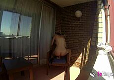 Sara Ray masturbates on a balcony for everyone in Madrid to see. Want to watch her play with that dildo in public?