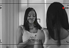 Behind the scenes, what's the hot brunette doing?