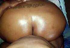 Ebony woman with big oiled ass in black setting