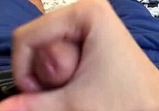 Male jerks off intensely on bed, losing NNN challenge with big cumshot.