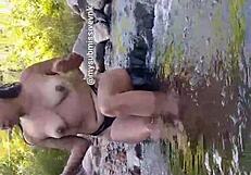 Brunette latina exhibitionist bathes in river with natural tits exposed and touches nipples
