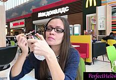 A young brunette woman engages in public interactions with strangers at the resort, leading to an unexpected encounter