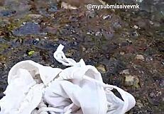 Brunette latina exhibitionist bathes in river with natural tits exposed and touches nipples