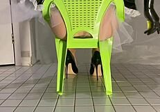 Maid cleans in pvc outfit dangling shoes