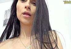 Slim girl with big tits sucks her own nipples on webcam in detailed close-up.