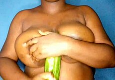 Ebony woman passionately caressing and admiring her big, busty tits