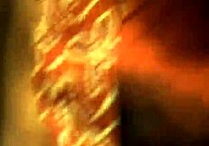 Brunette undresses while dancing in erotic striptease, teasing with ripped clothes.