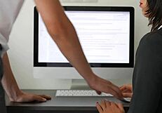 In the office, a sexy secretary gives her boss a massive cumshot handjob.