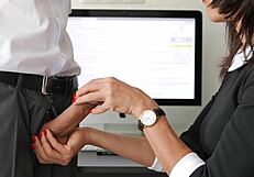 In the office, a sexy secretary gives her boss a massive cumshot handjob.