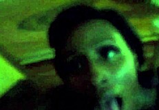 Ebony woman performing oral on a large black phallus