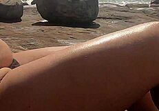 Stunning young African caught having outdoor sex on beach rocks