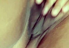 Sexy latina masturbates her wet hairy pussy on bed.