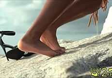 Giggles rubs her petite feet all over my huge cock at the beach