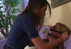 Horny brunette makes her blonde friend watch as she fucks her man on the couch.