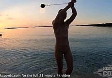 nude fire dancer seduces on beach at sunset